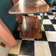 Elegant vintage serving trolley on wheels, two wooden shelves.