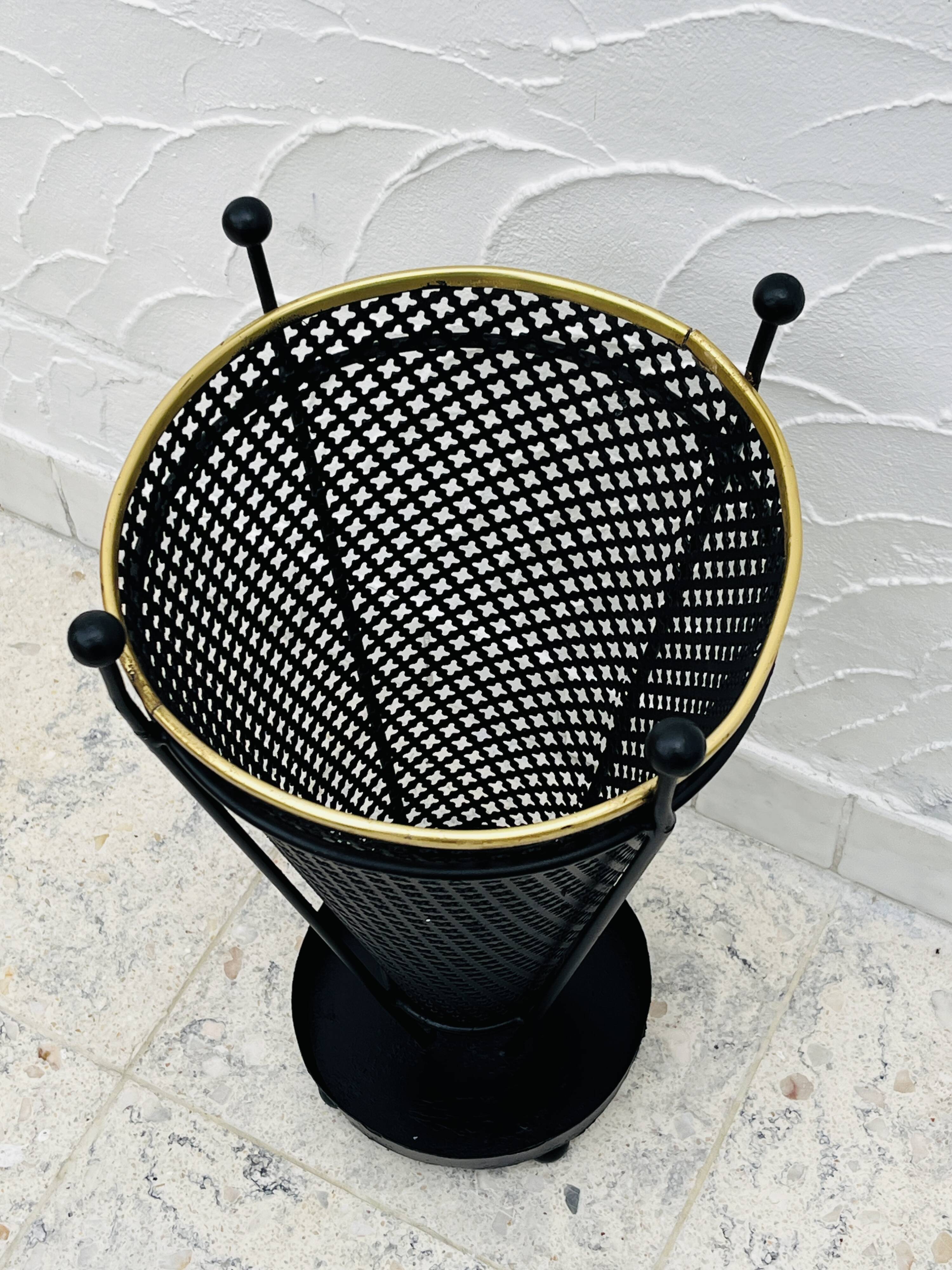 Vintage black perforated metal and brass umbrella stand