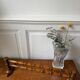 Wall-mounted coat rack made of turned wood in a bamboo style.