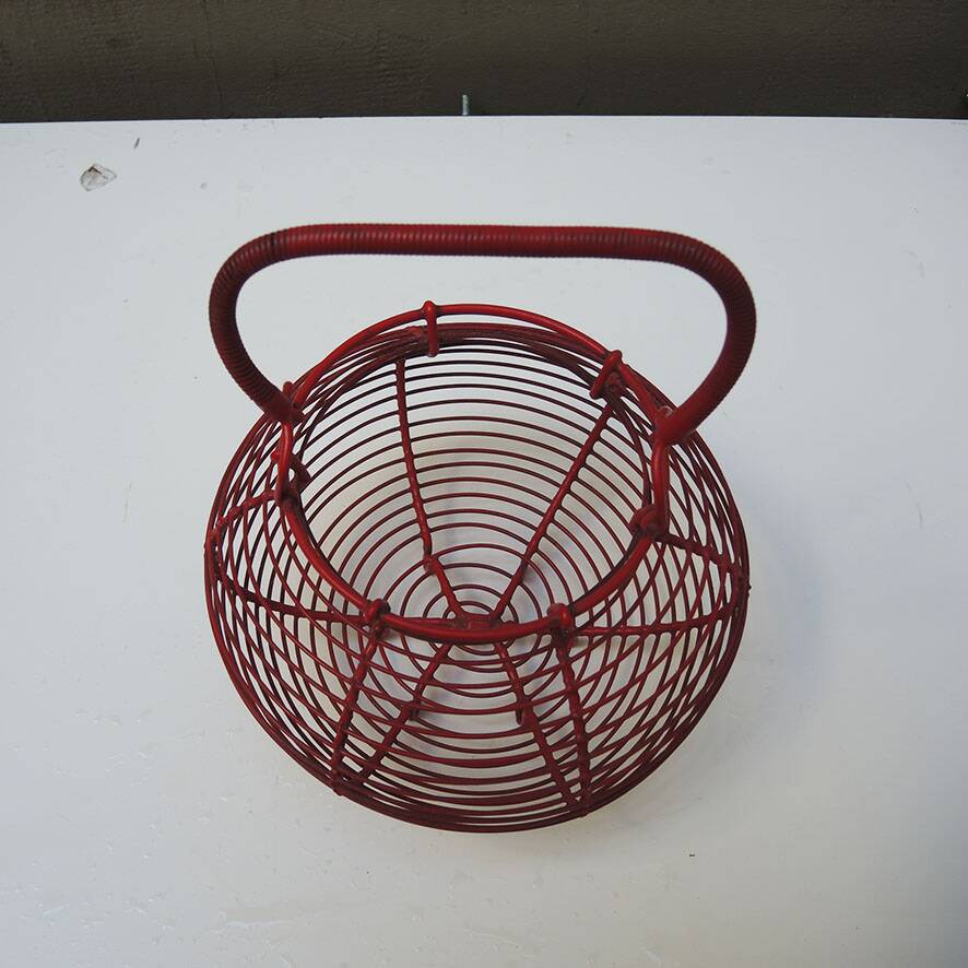 Old red-painted metal egg basket
