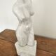 Sculpture of a female torso in white marble.