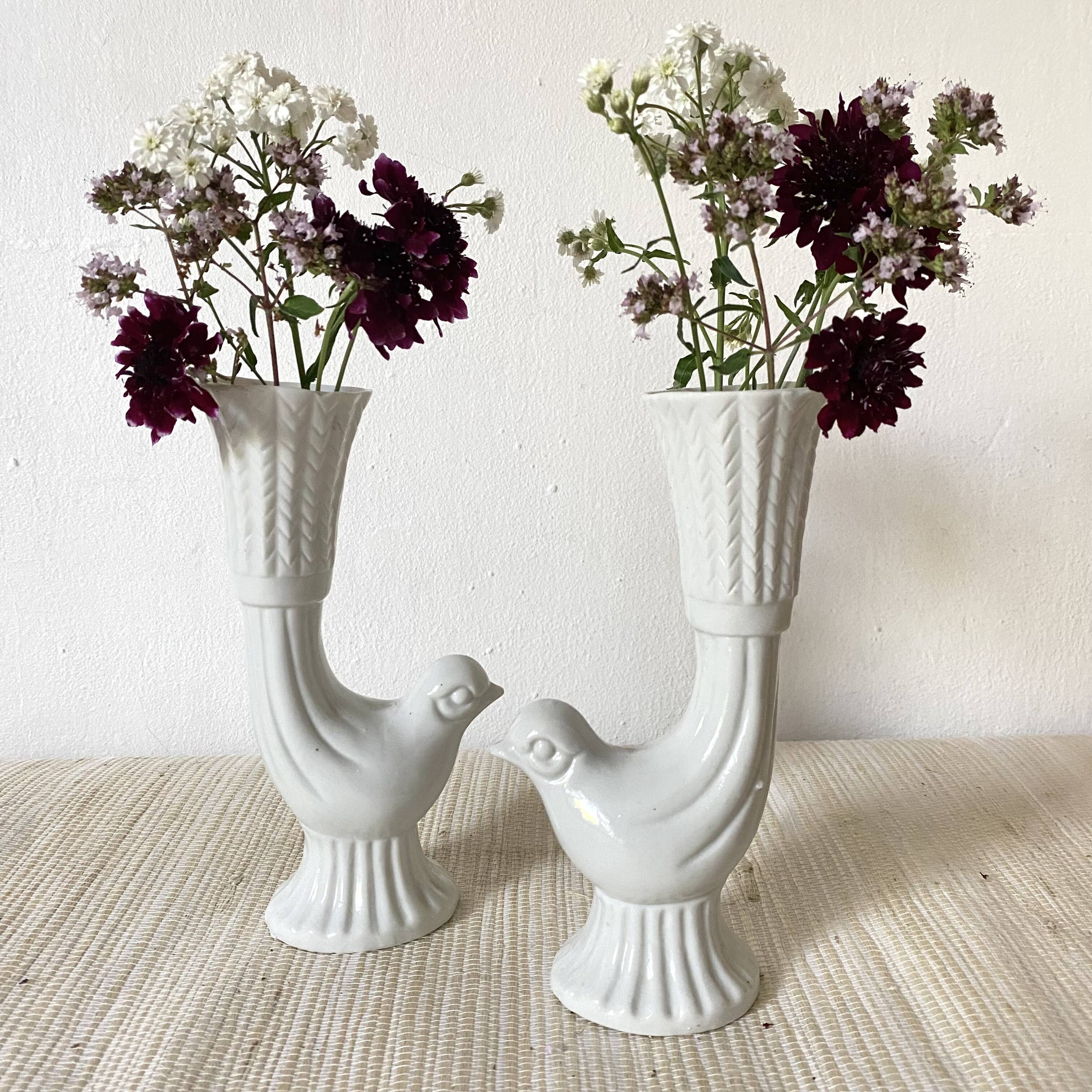 Pair of porcelain candle holders and bird vases