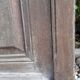 Oak entrance door and its frame and transom, wrought iron gates