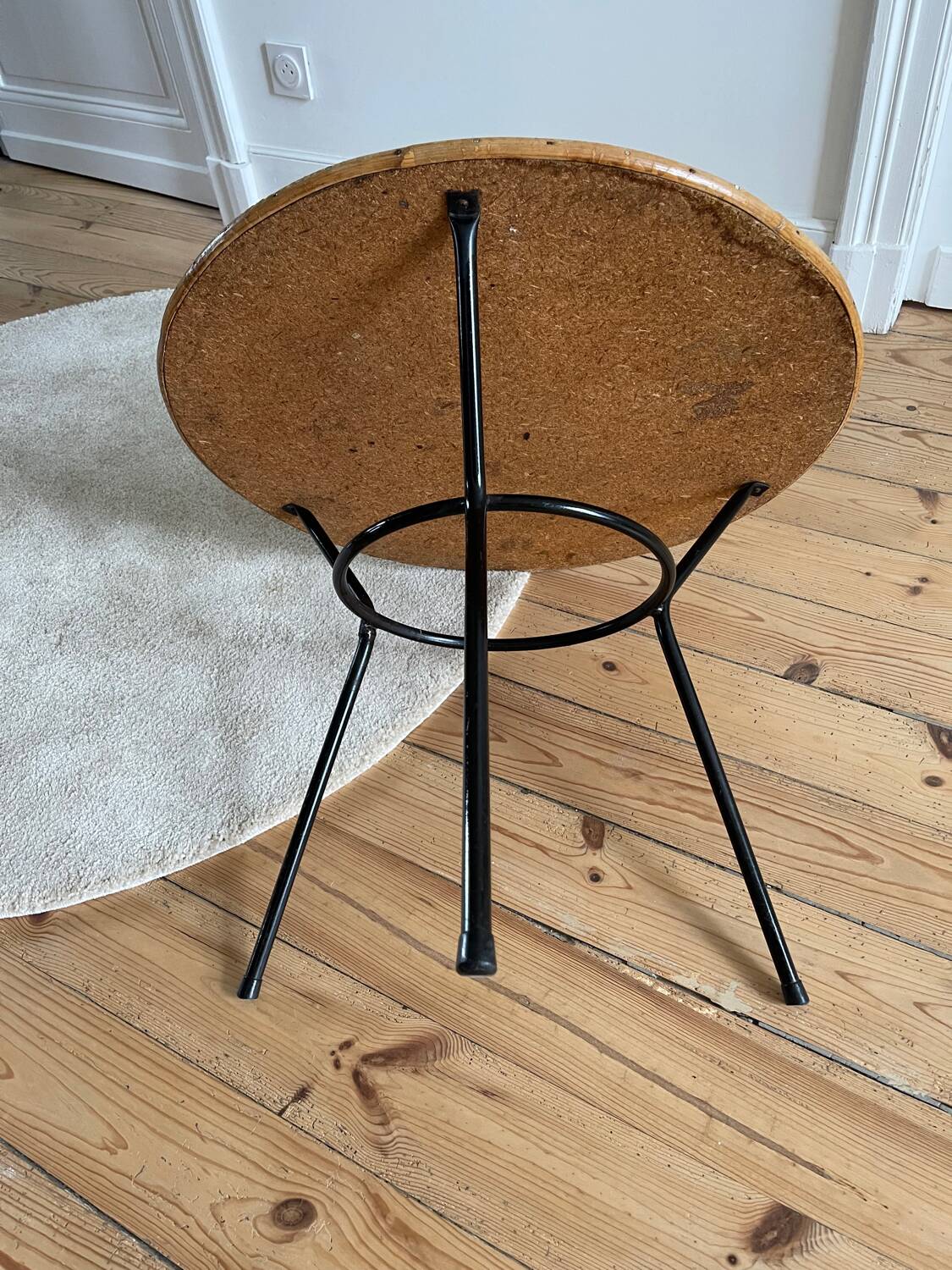 Tripod coffee table with a straw covering.
