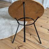 Tripod coffee table with a straw covering.