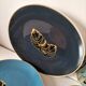 Set of 7 porcelain plates, gold foliage & jungle