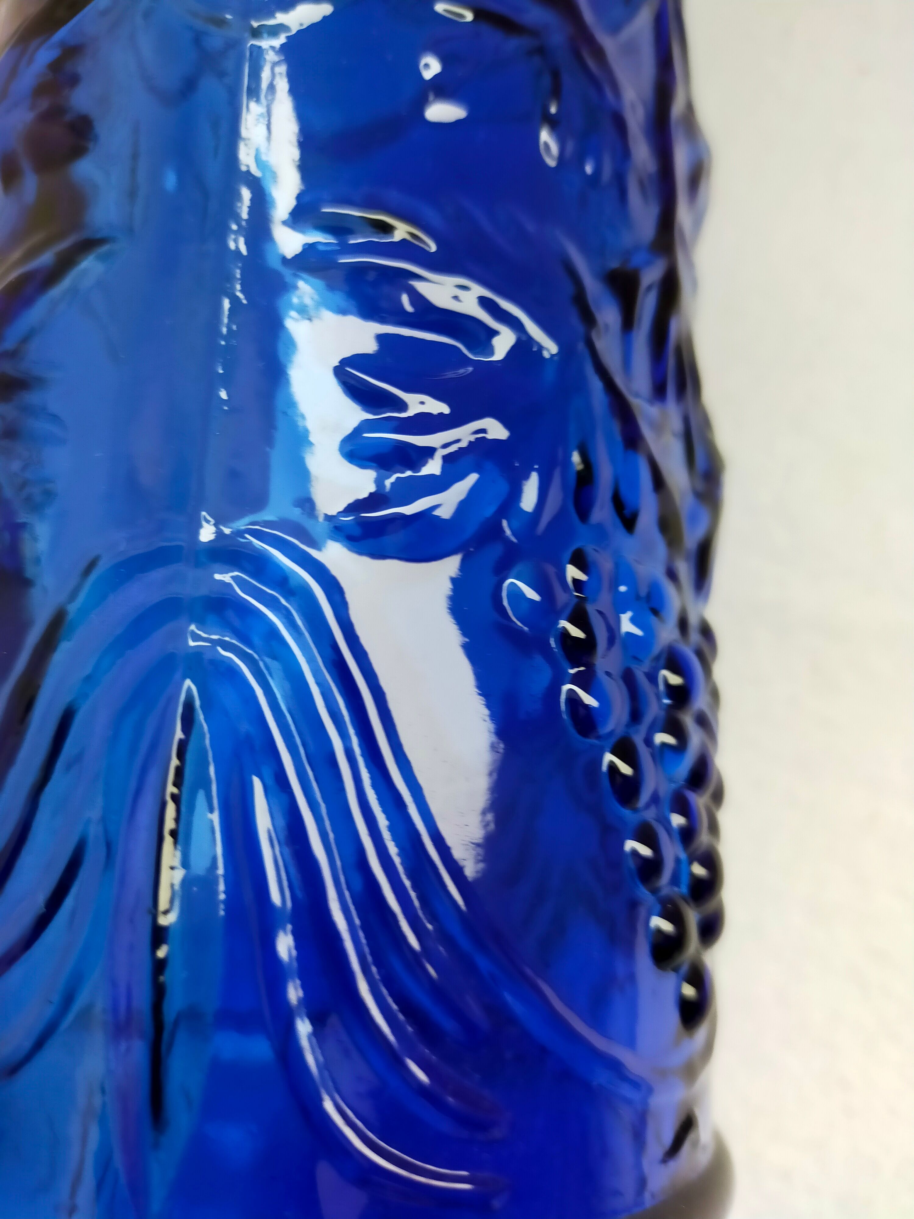 cobalt blue molded glass bottle in relief decoration bunches of grapes