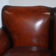 Restored Victorian sofa in leather with claw feet and feather cushions.