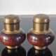Vintage salt and pepper shaker duo in brass and turned wood.