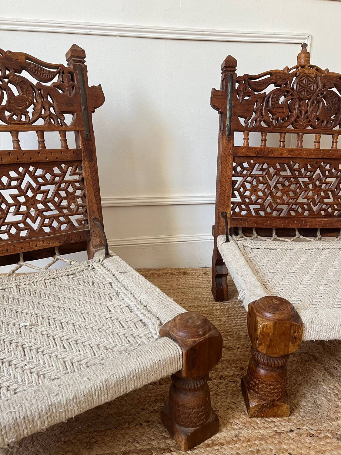 Pair of traditional Indian chairs made of carved wood and rope