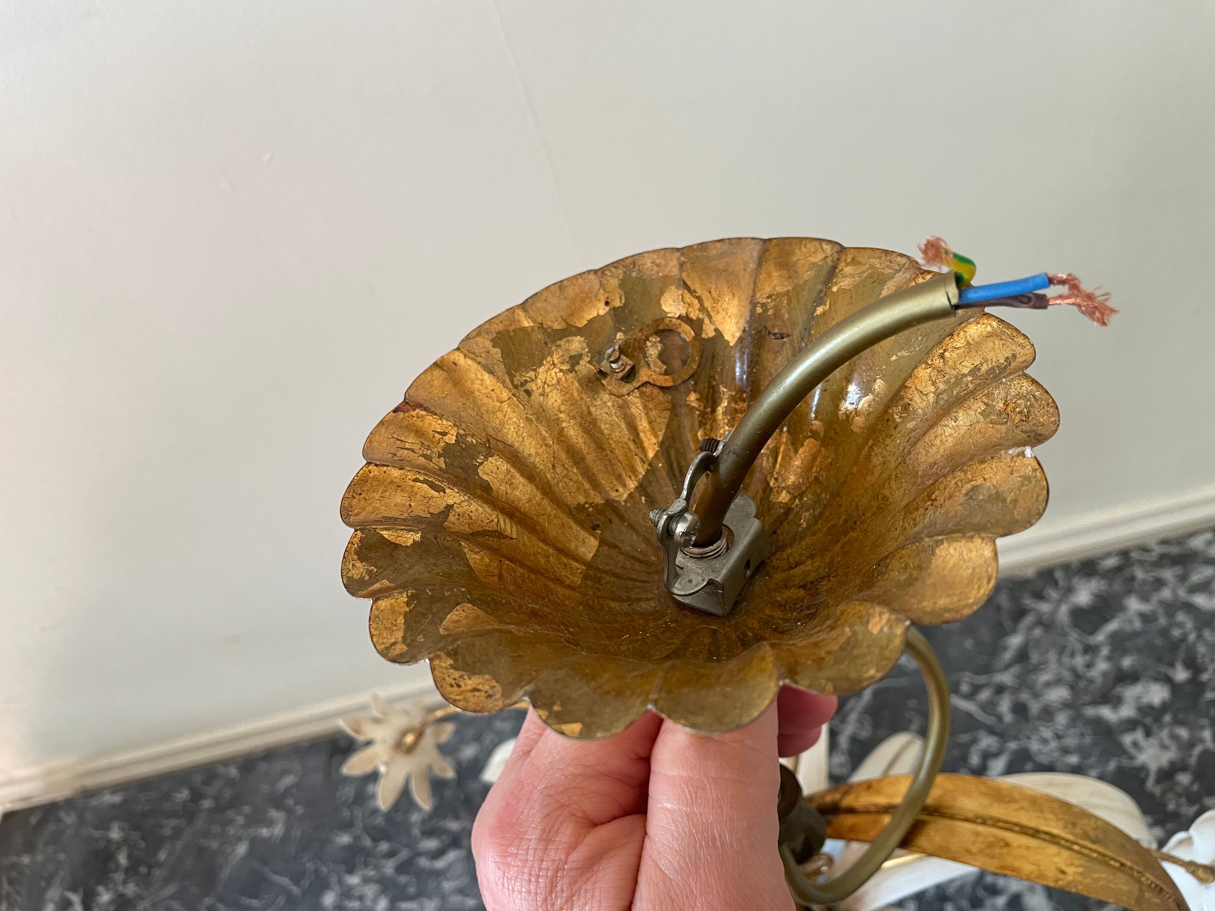 Golden metal chandelier decorated with flowers