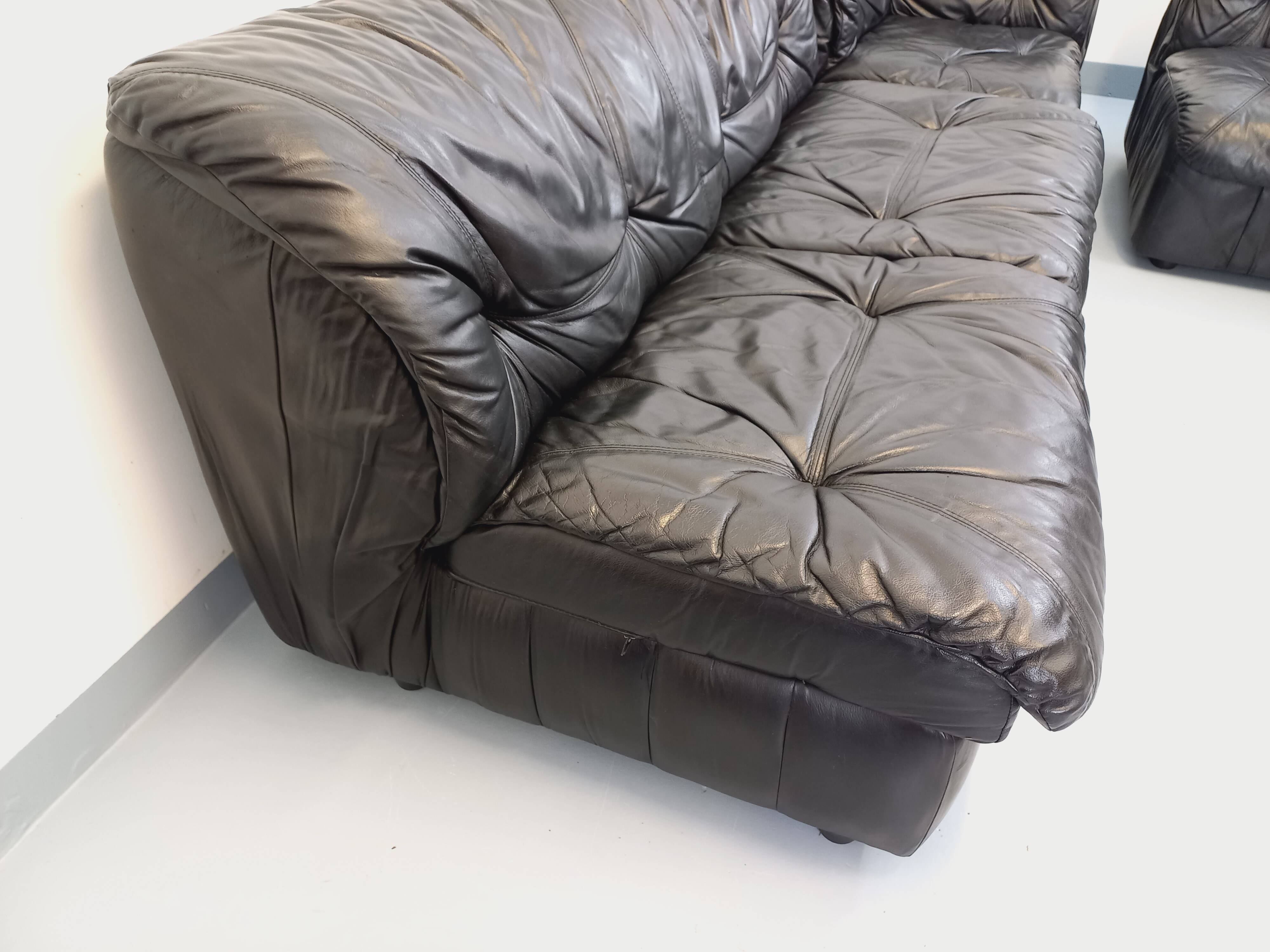Vintage corner sofa composed of 3 modules in black leather with integrated bed.