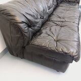 Vintage corner sofa composed of 3 modules in black leather with integrated bed.