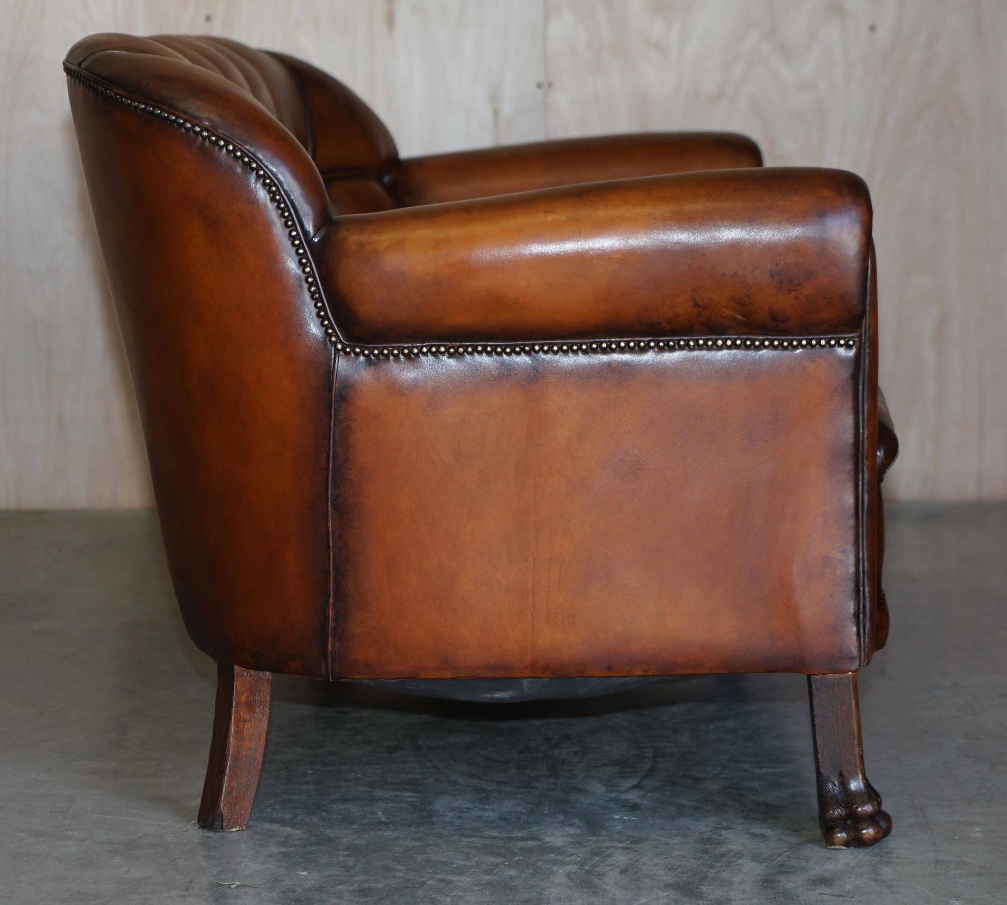 Victorian Chesterfield leather canapé with oak lion claw feet.