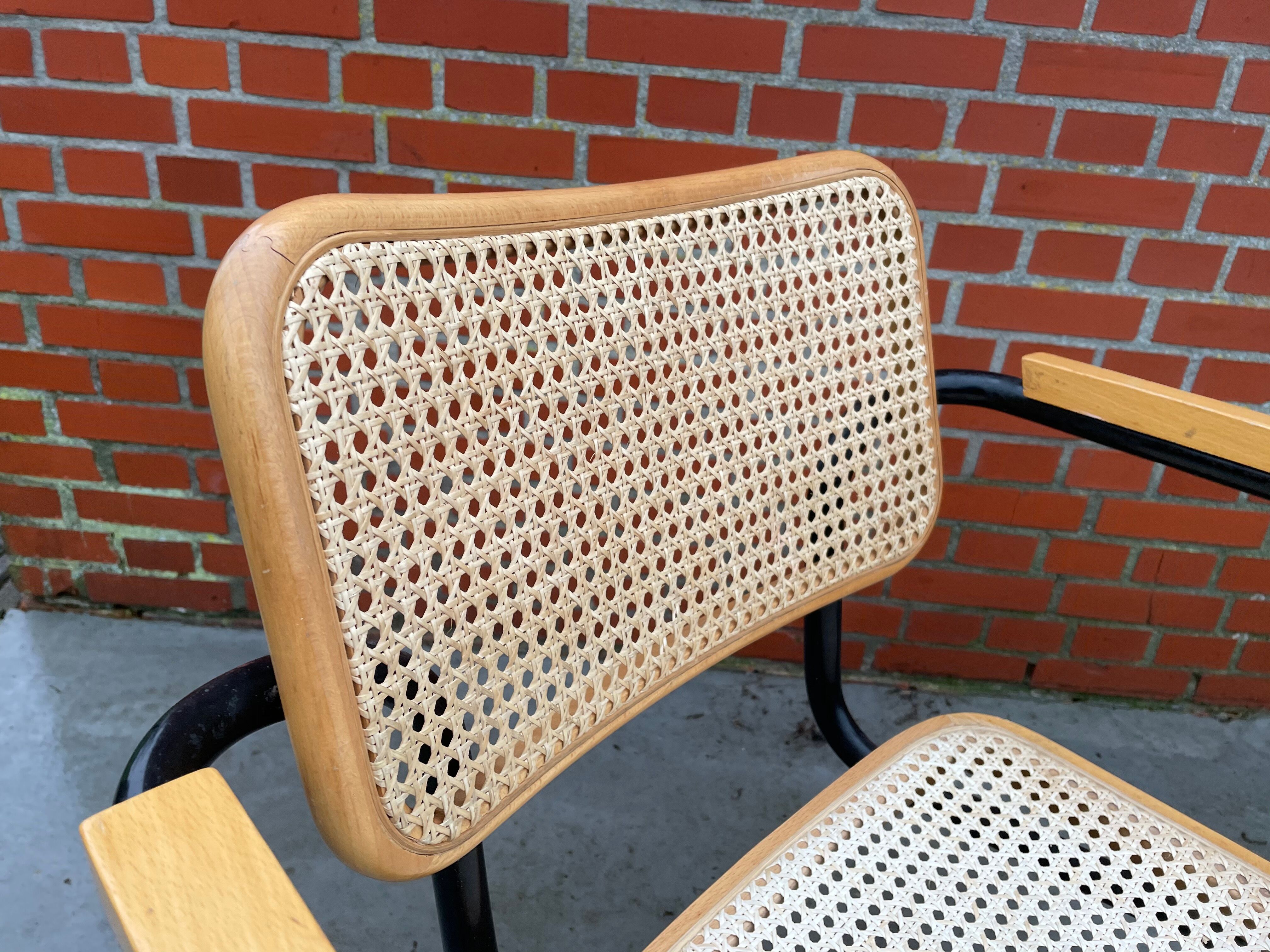 Cesca model chair designed by Marcel Breuer with black-framed armrests