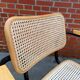 Cesca model chair designed by Marcel Breuer with black-framed armrests