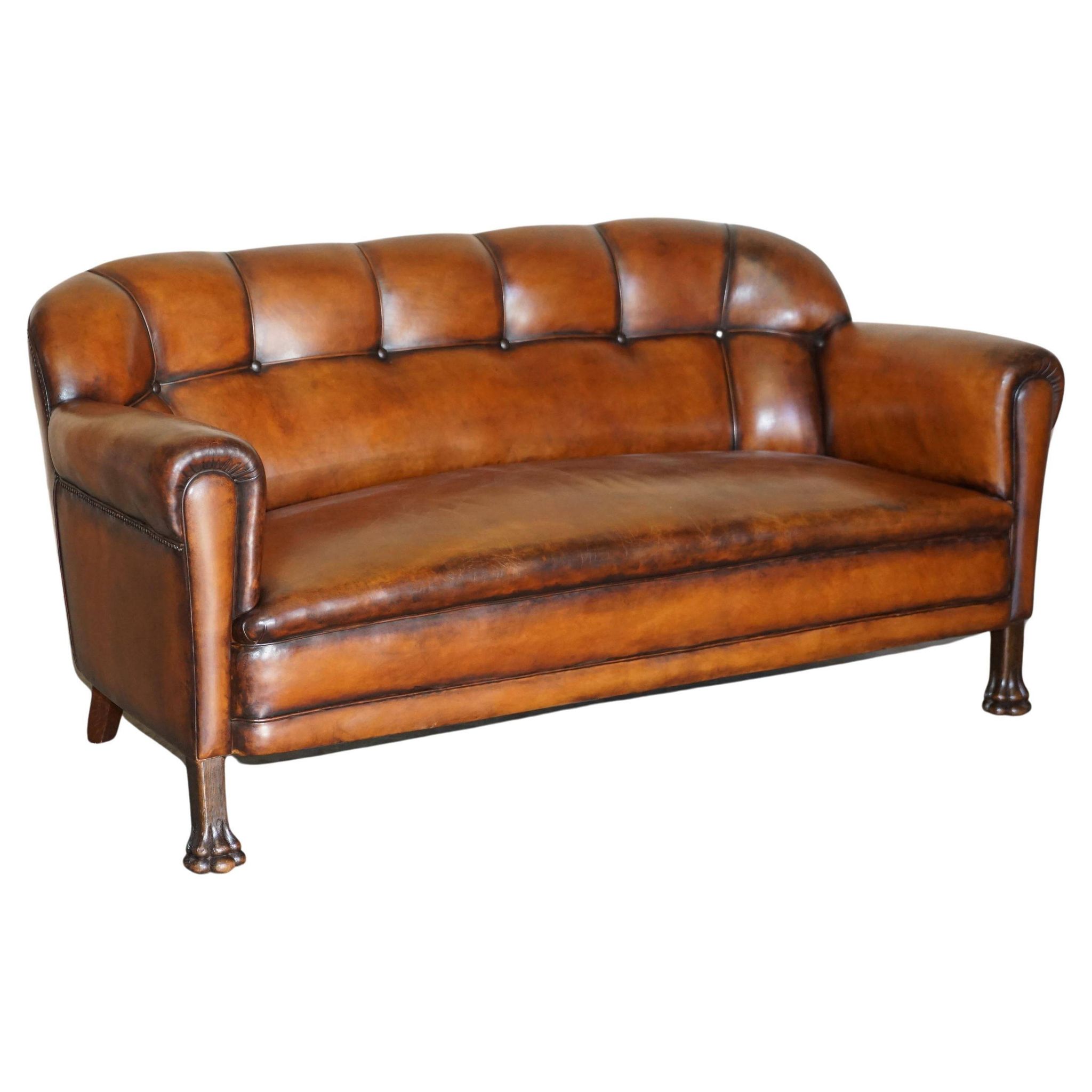 Victorian Chesterfield leather canapé with oak lion claw feet.