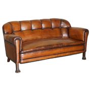 Victorian Chesterfield leather canapé with oak lion claw feet.