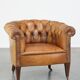 Antique, characteristic sheepskin chesterfield club chair on wheels