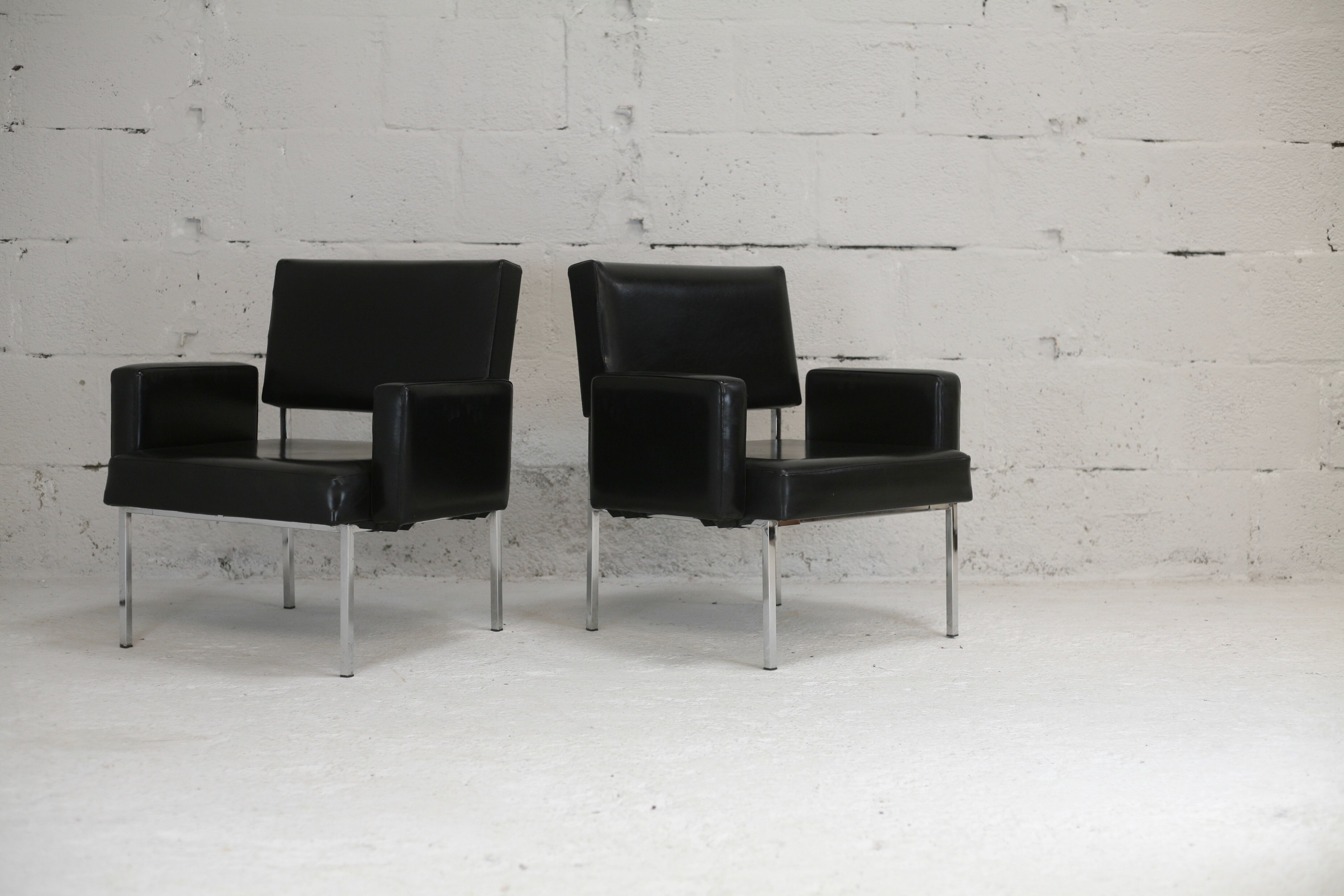 Pair of stainless steel, black leather-like armchairs, France, circa 1970