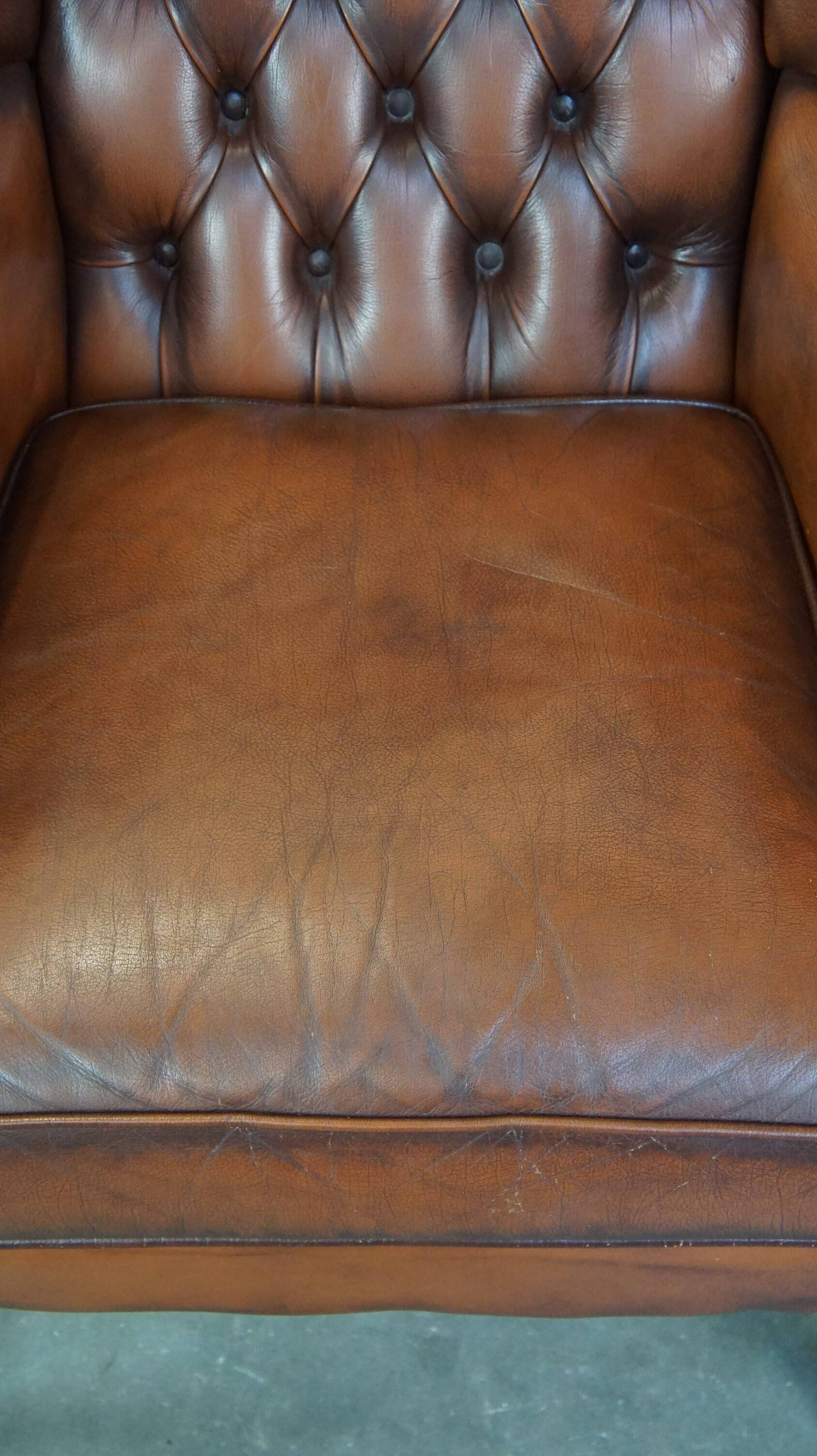 Brown leather wingback Chesterfield armchair