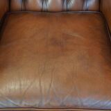 Very beautiful, stately, cowhide Chesterfield wing chair with elegant legs in a nice brown color