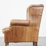 Graceful, stylish, timeless and comfortable wing chair made of cowhide in English style