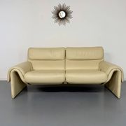 Two-seater designer sofa De Sede DS-2011 in cream leather with adjustable backrest.