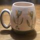 Set of two ceramic mugs signed Yvon ROY.
