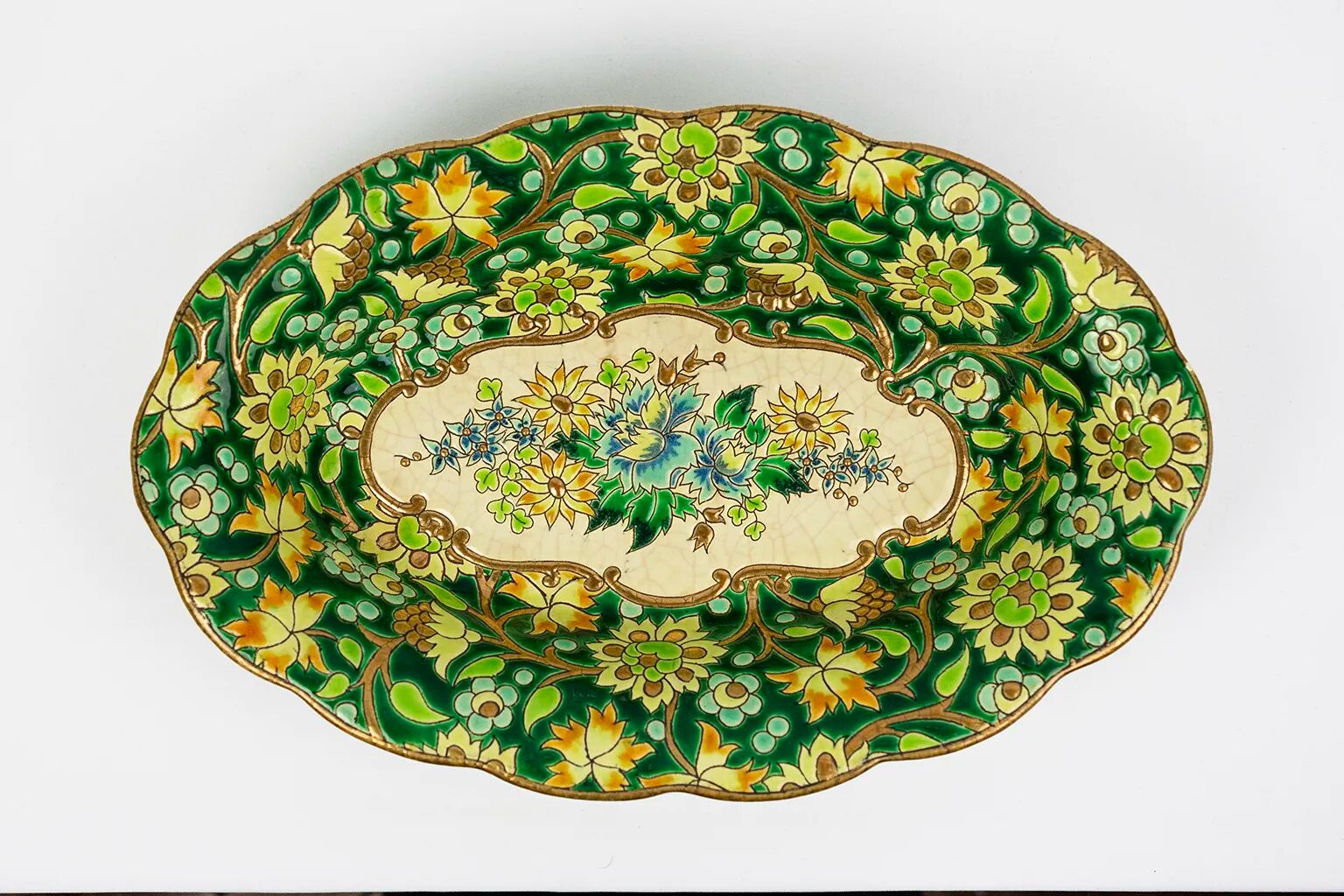 Longwy cup in cloisonné enamels on a green background, polychrome floral decoration and gold