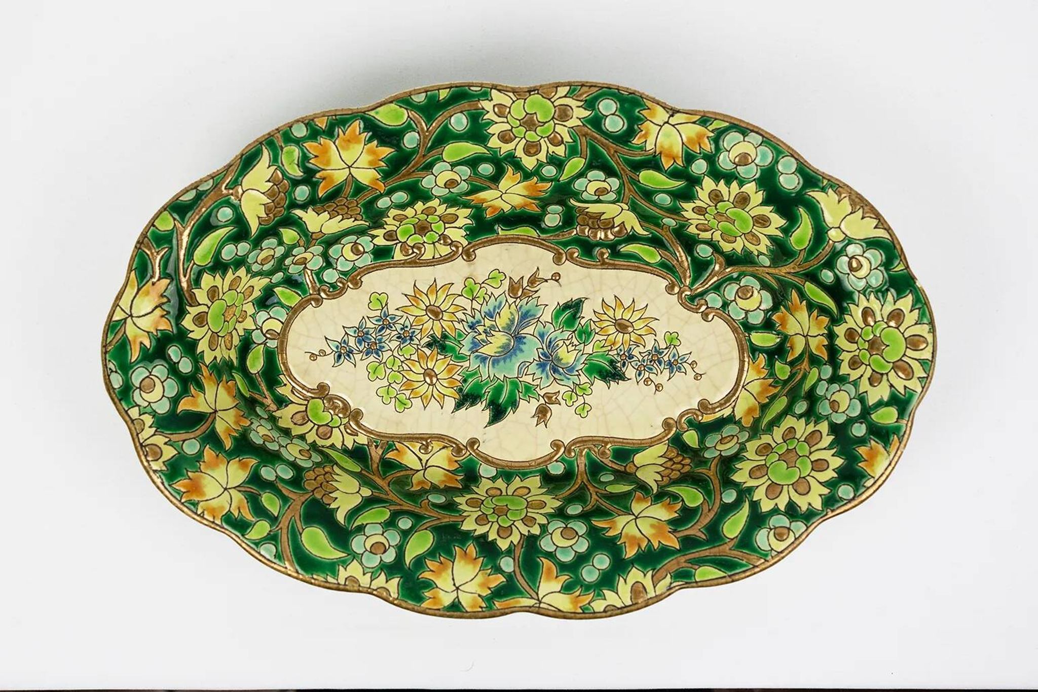 Longwy cup in cloisonné enamels on a green background, polychrome floral decoration and gold