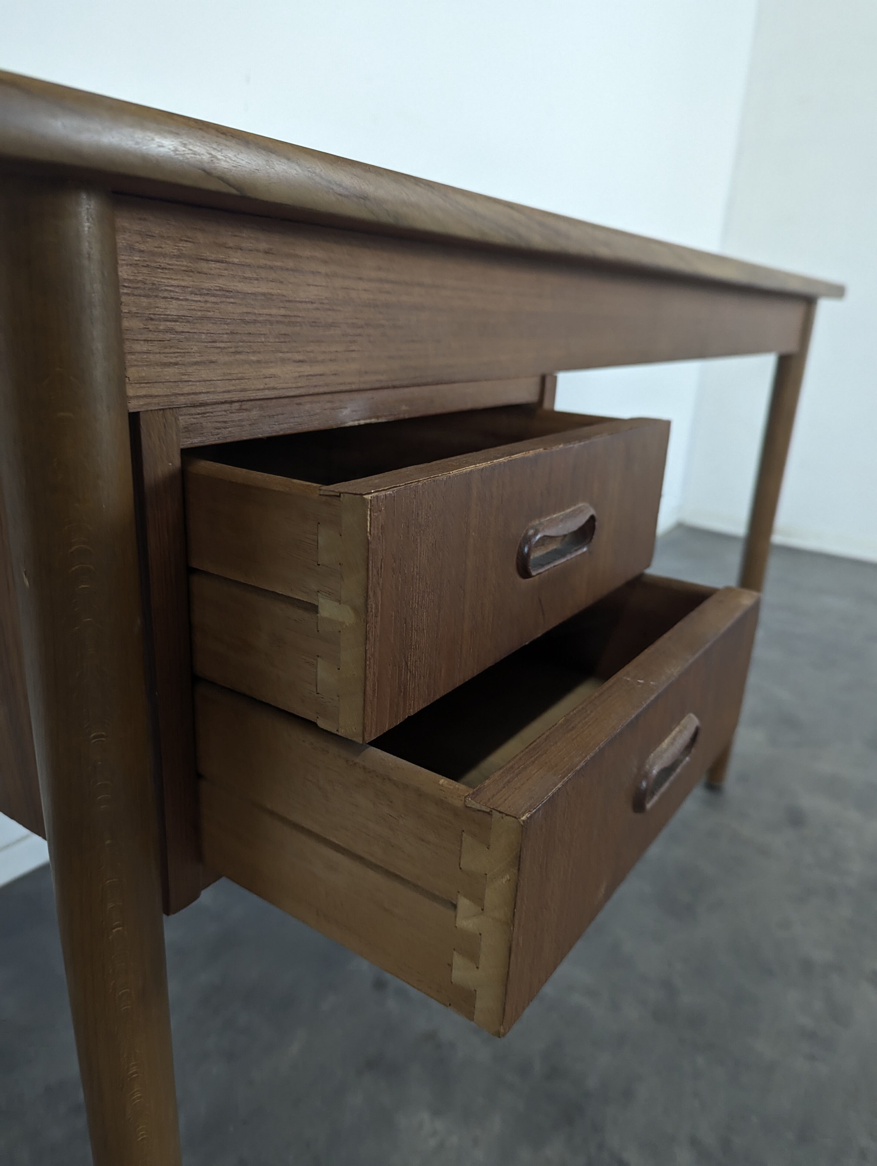 Scandinavian teak desk with a suspended drawer unit.