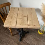 Bistro table with a central cast iron base in industrial style.