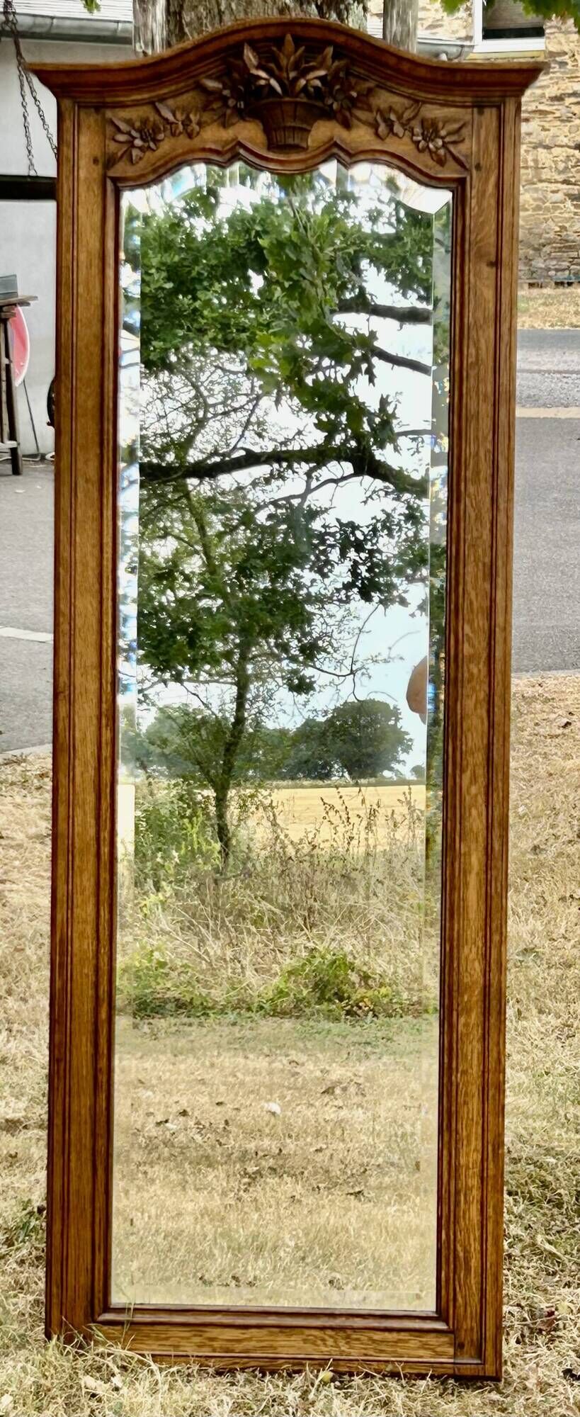 Large and old bevelled framed floor mirror.
