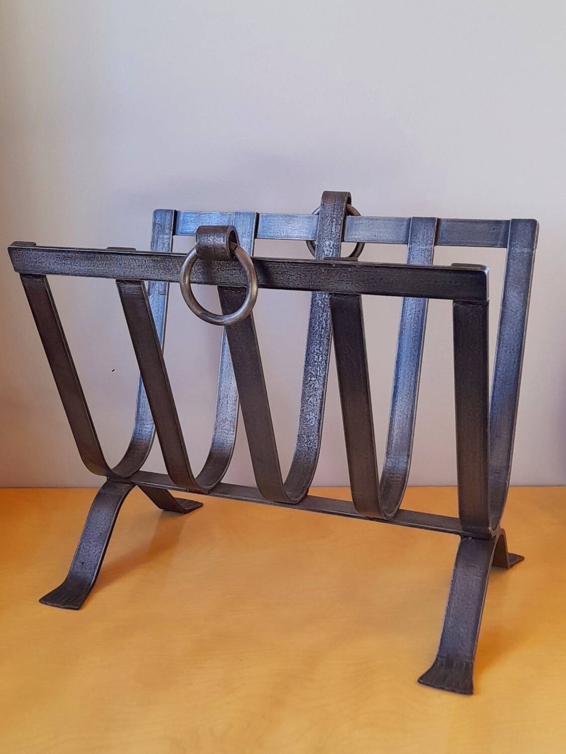 Brutalist magazine rack in forged steel, 1950.