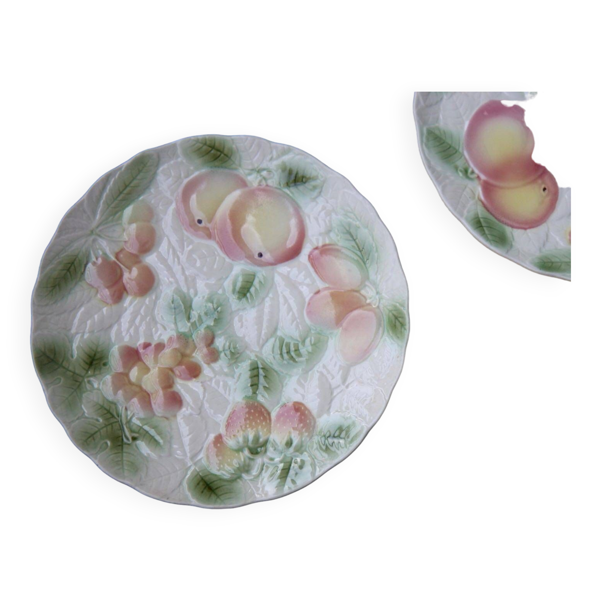 Two slip plates decorated with fruit.