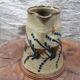Hand-decorated and signed berry earthen pitcher