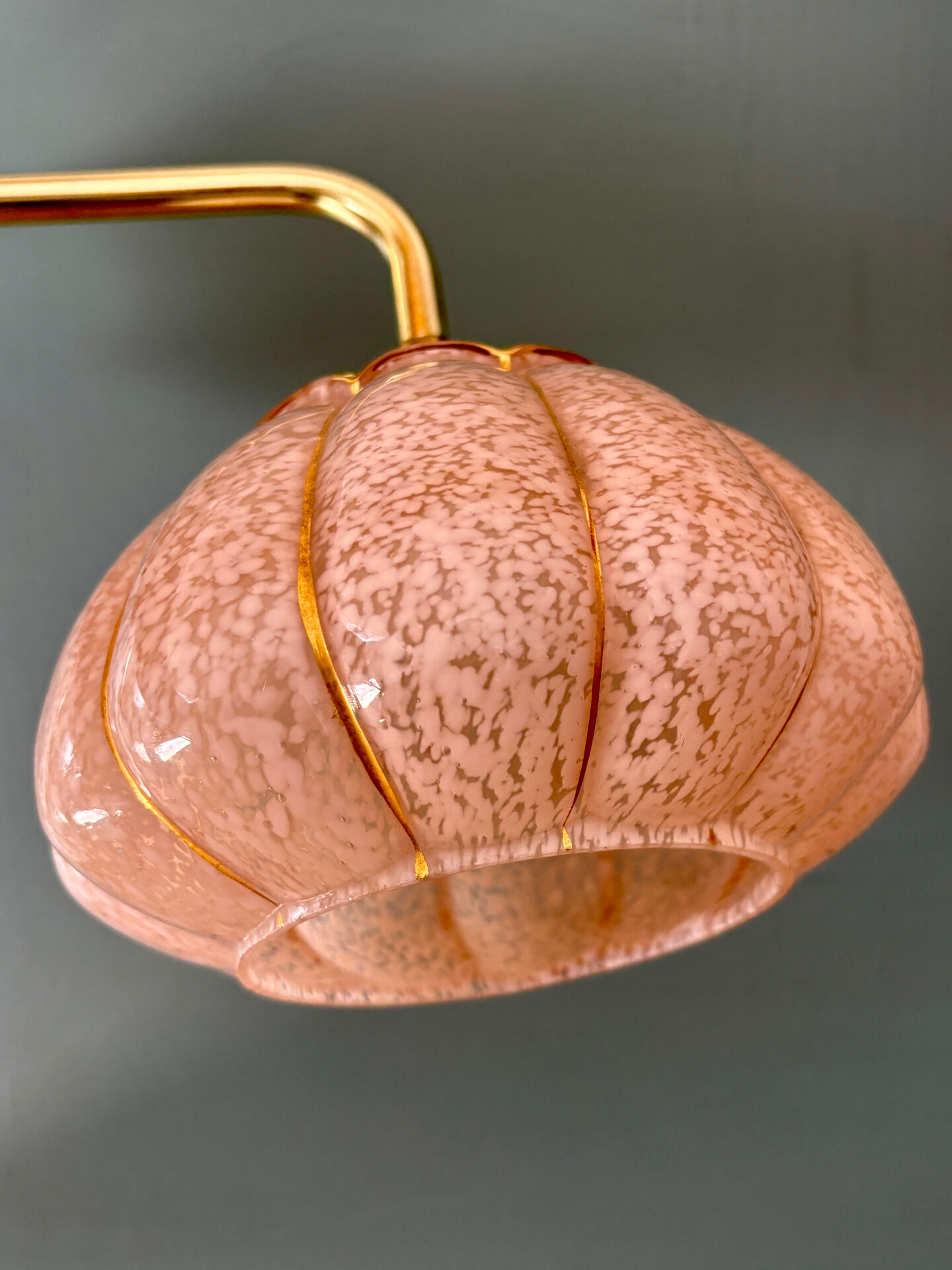 Vintage glass wall light with a pink and gold Clichy globe.