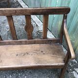 Duo of old solid oak benches with backs and armrests.