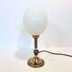 Ostrich egg lamp on a brass stand, antique curiosity cabinet.