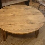 Large round antique coffee table made of raw solid wood.