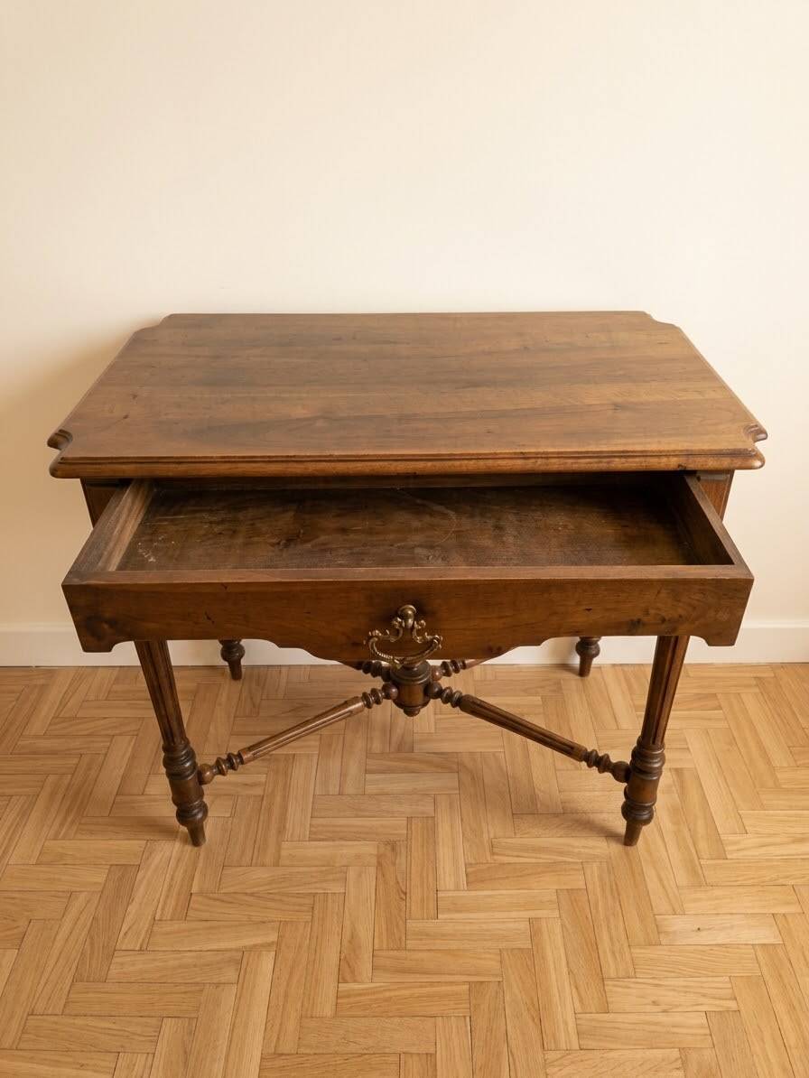 Antique walnut desk with a drawer and turned legs.
