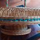 Glass holder and wicker bottle with green plastic water surface