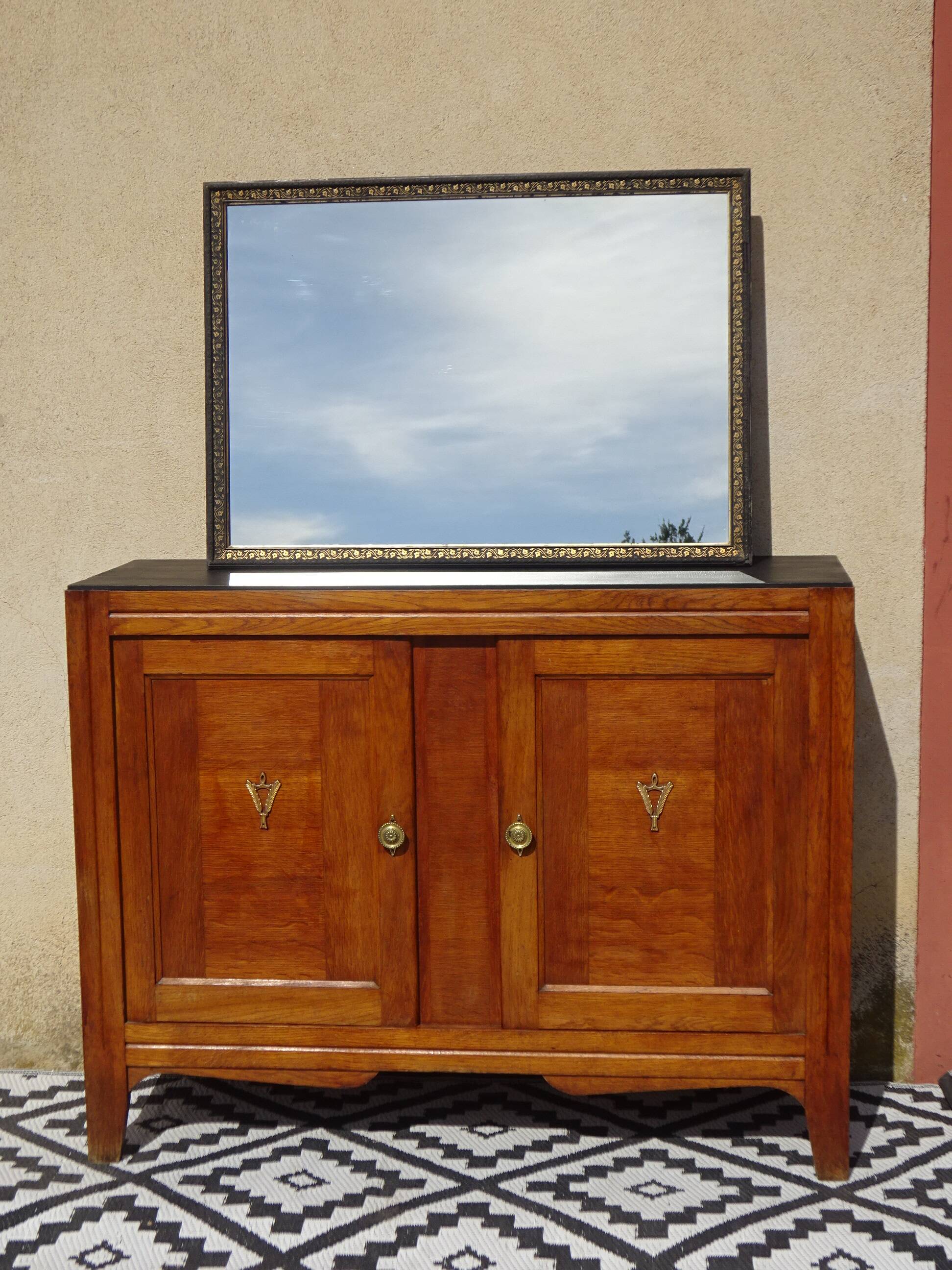 Mirror with black and gold frame, embossed vine leaves
