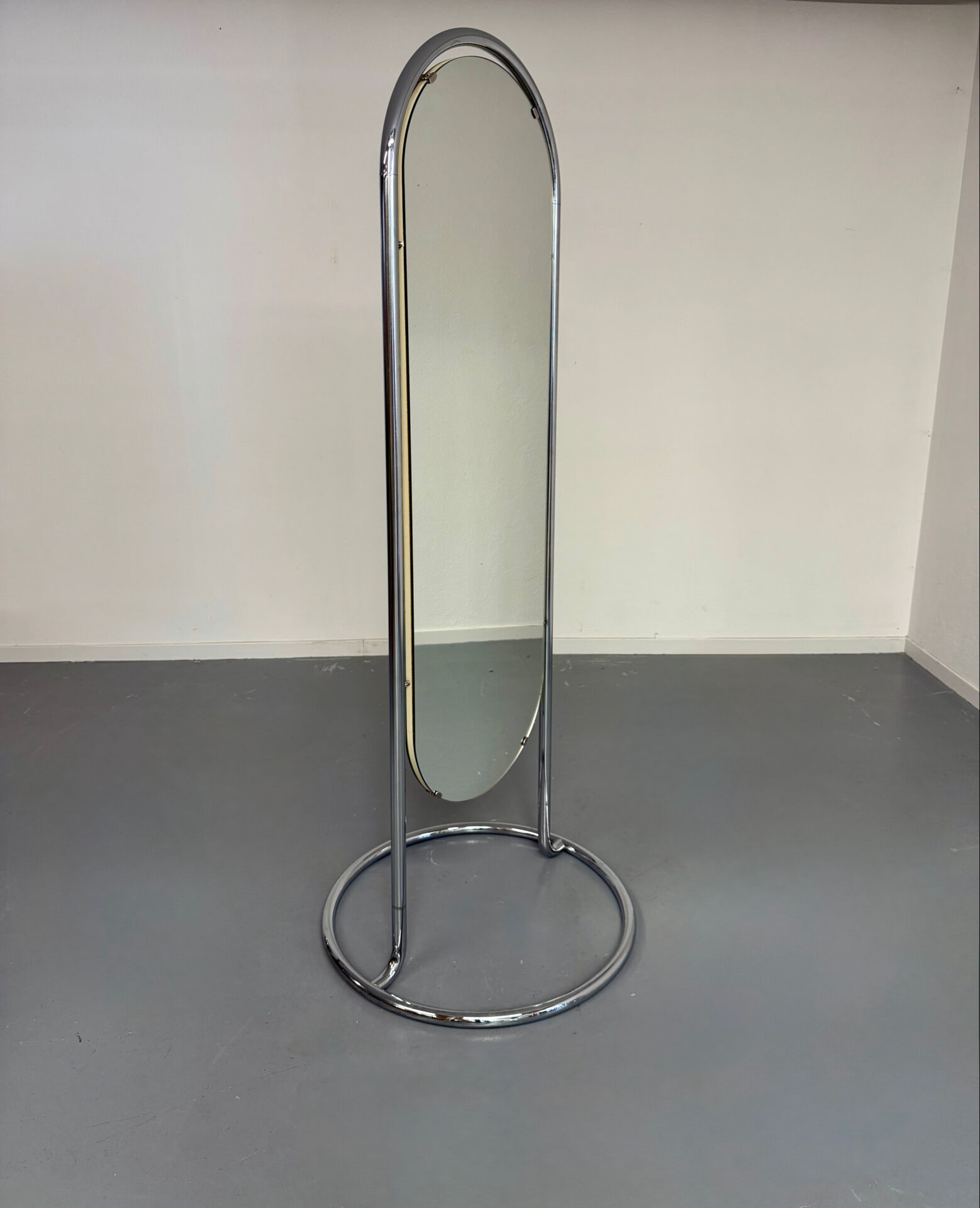Large freestanding chrome metal full-length mirror in 1970s design.