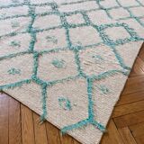 Berber cream carpet with blue pattern