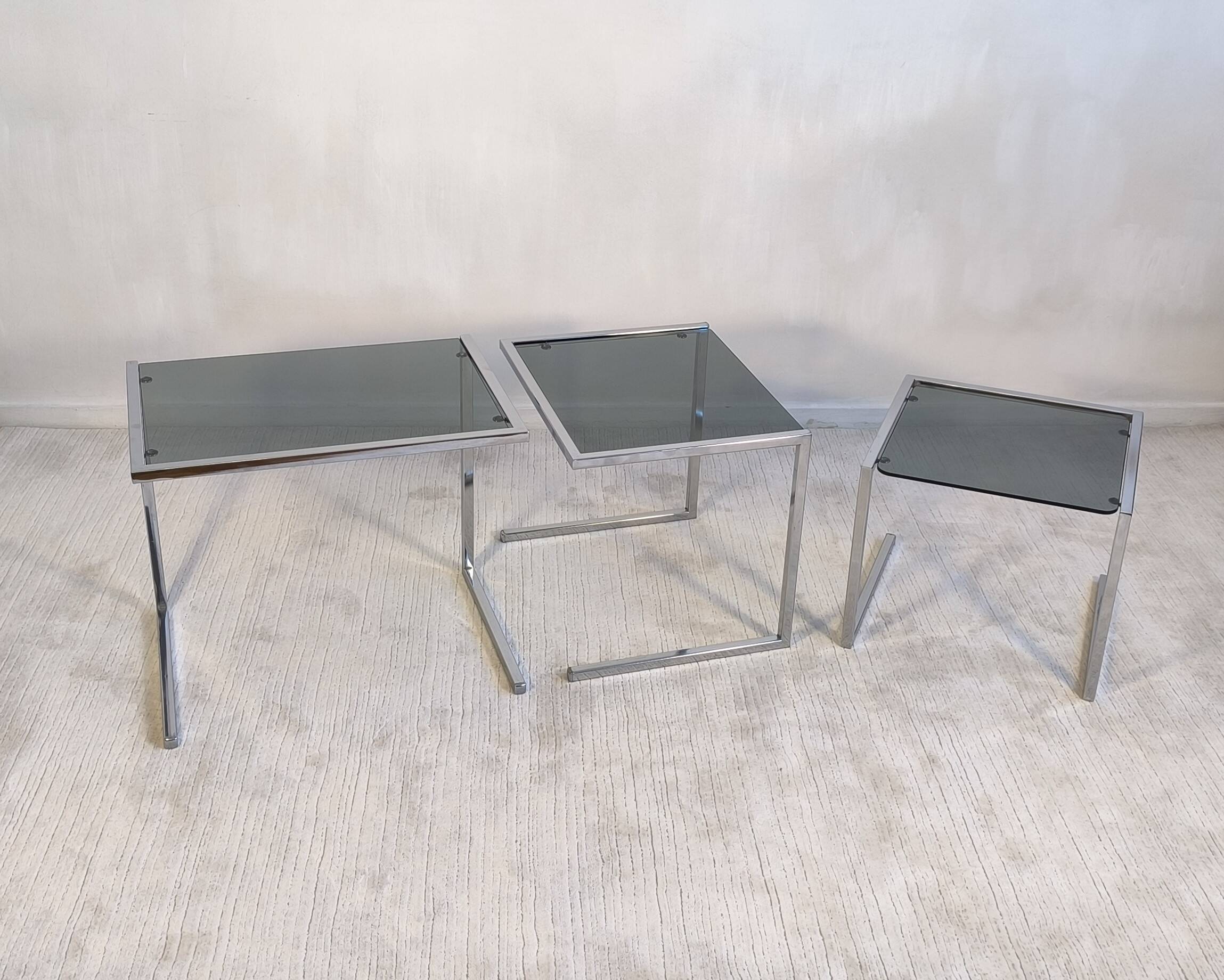 Set of 3 vintage nesting tables in chrome and smoked glass, Roche Bobois style.