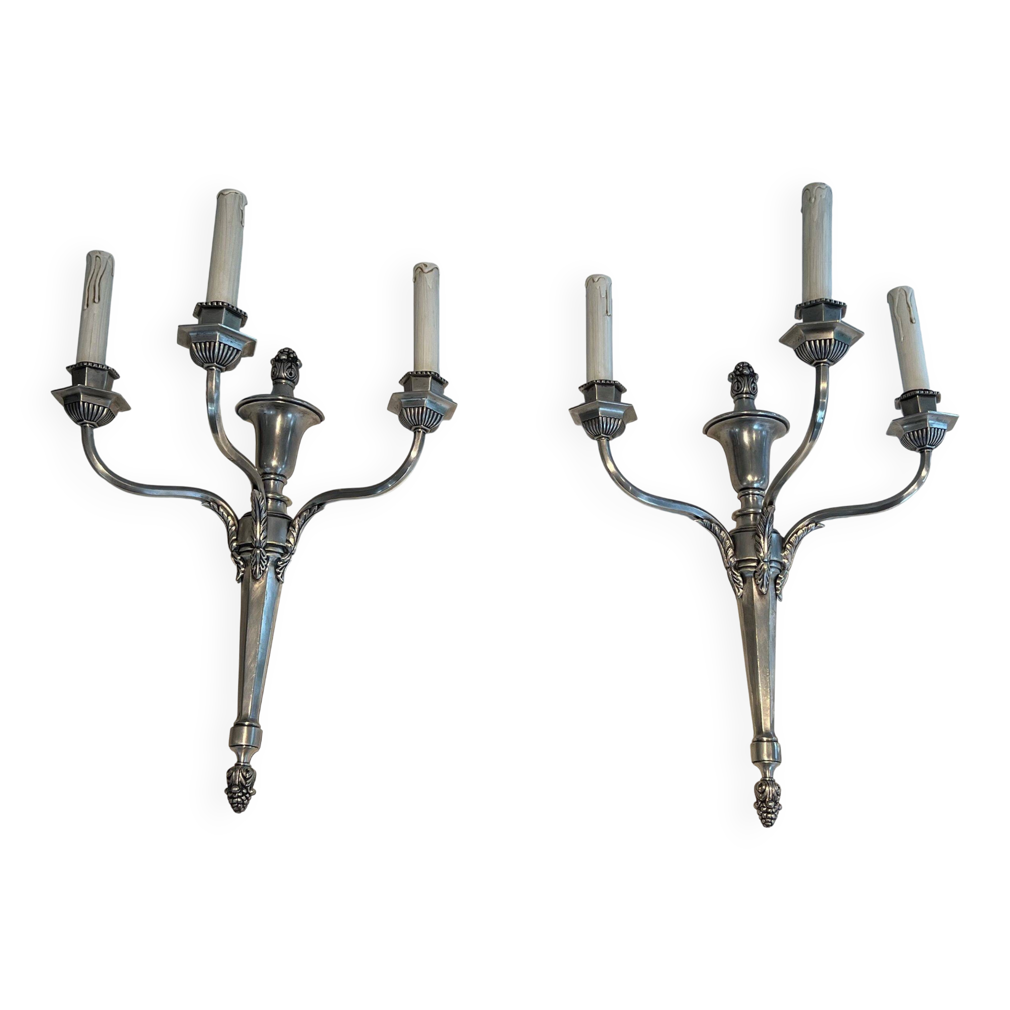 A pair of important Louis XVI style silver-plated wall sconces with three light arms.