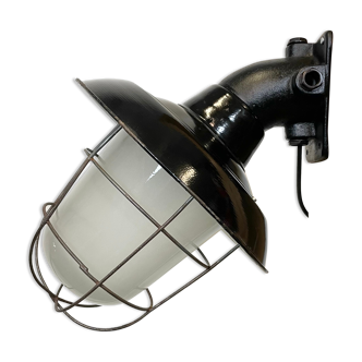 Industrial black enamel and cast iron wall lamp with iron grid, 1960s