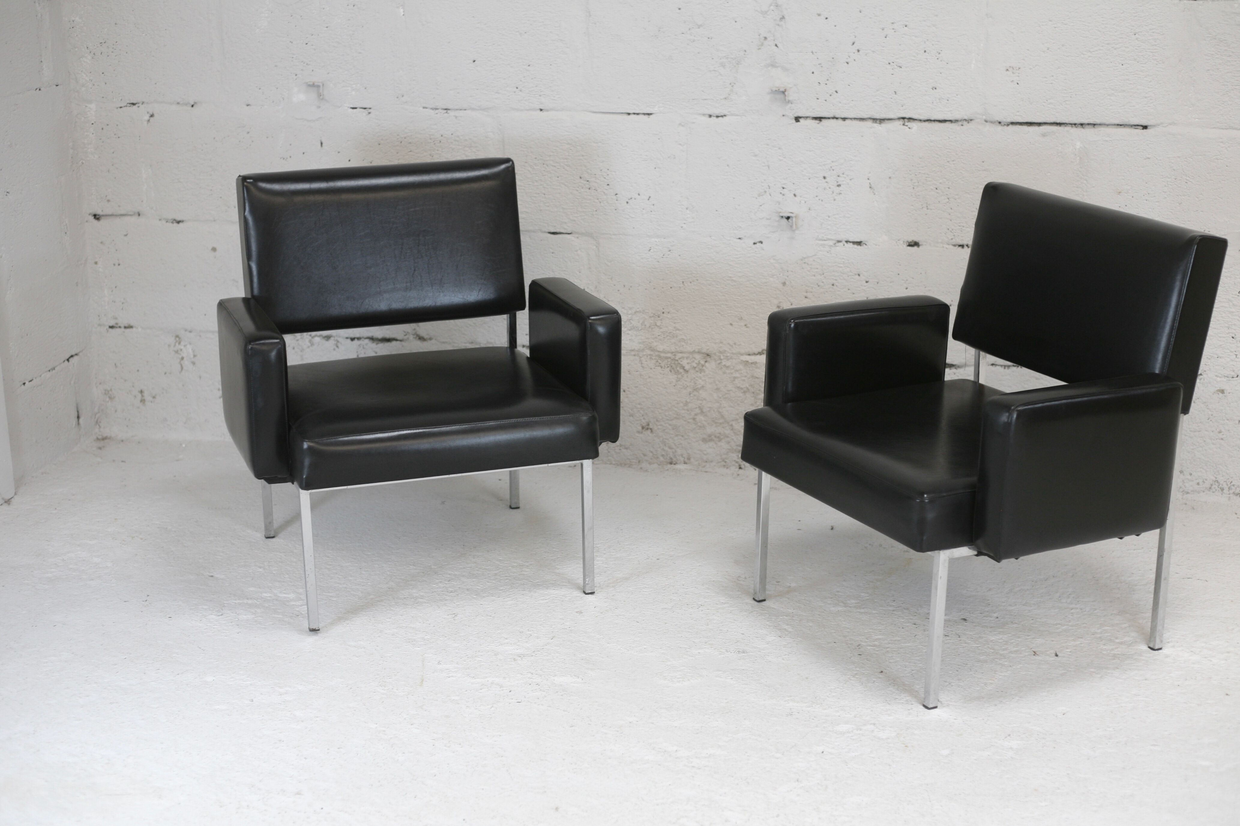 Pair of stainless steel, black leather-like armchairs, France, circa 1970